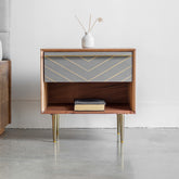 Toshi Wooden Bedside Table is made with Acacia wood, cement inlay, and brass-finished legs. A modern bedside table with a unique urban chic design.